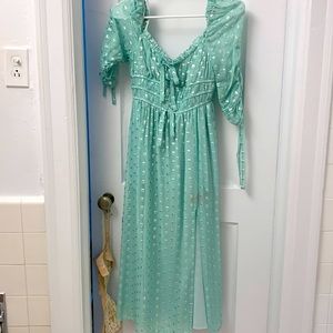 Lightly worn For Love and Lemons dress in mint green with a silver hearts.